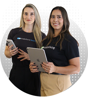 Duas profissionais sorrindo, usando camisetas da empresa, segurando um celular e um tablet